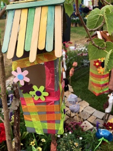 Bird house with ice lolly stick roof, ribbons and flowers