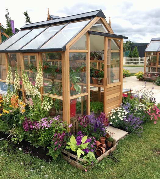 Gabriel Ash timber framed greenhouse with flowers