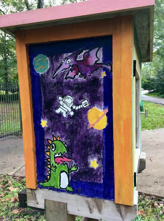 Dinosaurs, spacemen and planets on a street library