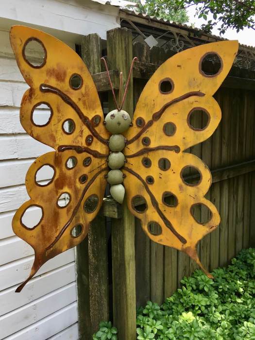 Yard art: yellow butterfly with cute face