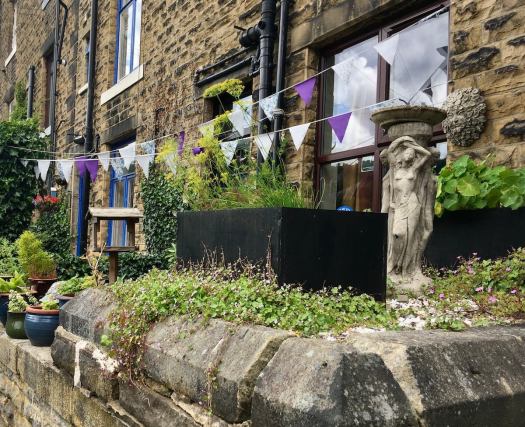 Terraced house garden with art and bunting